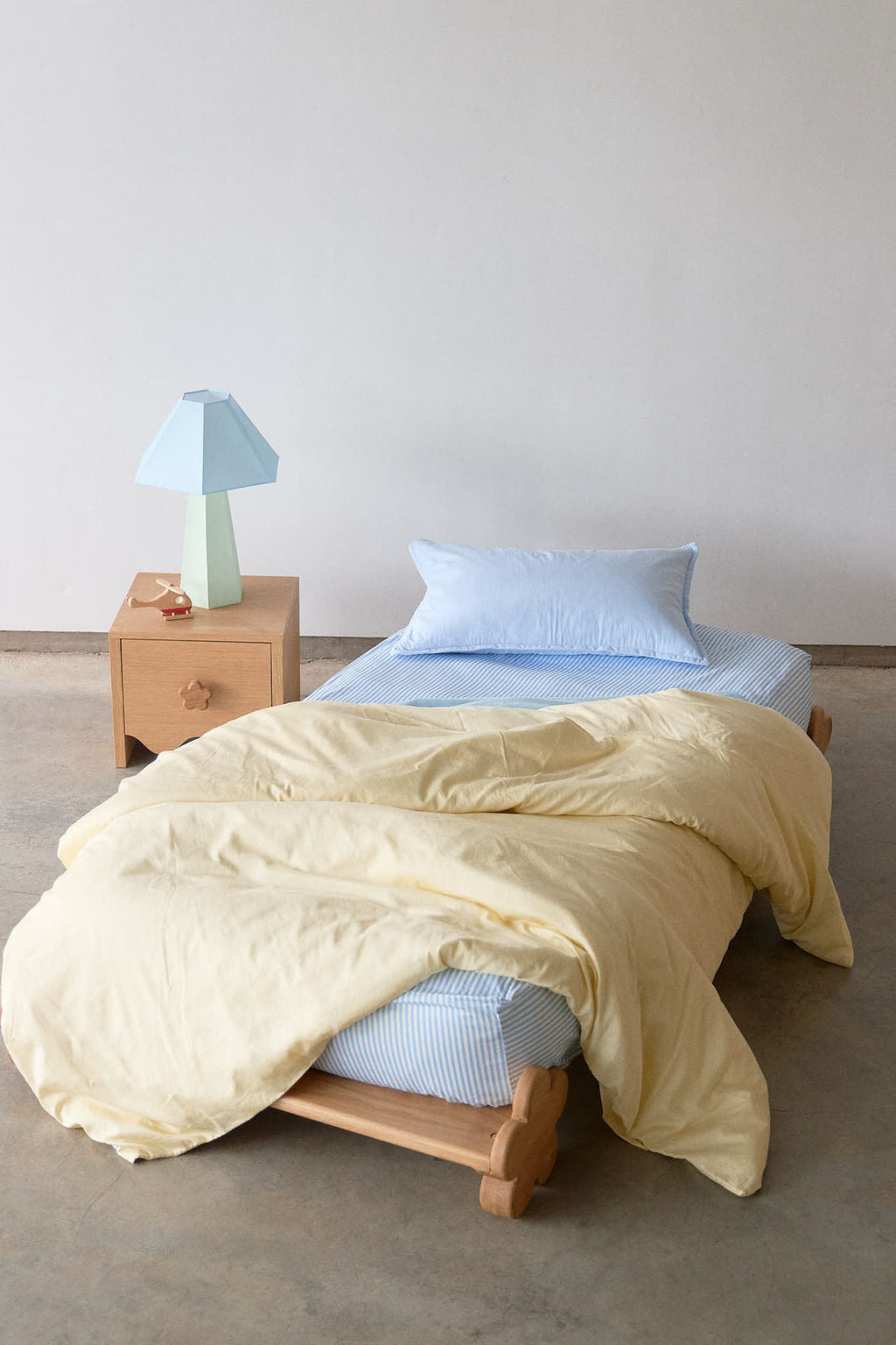 Organic Peach waterproof fitted sheet on a neatly made bed